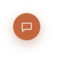 The closed chat launcher — a round terracotta button in the page corner